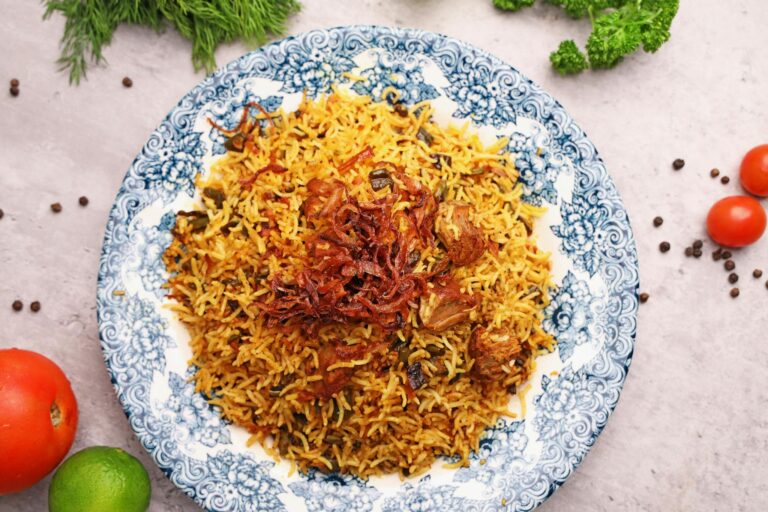 A plate of rice with vegetables and spices